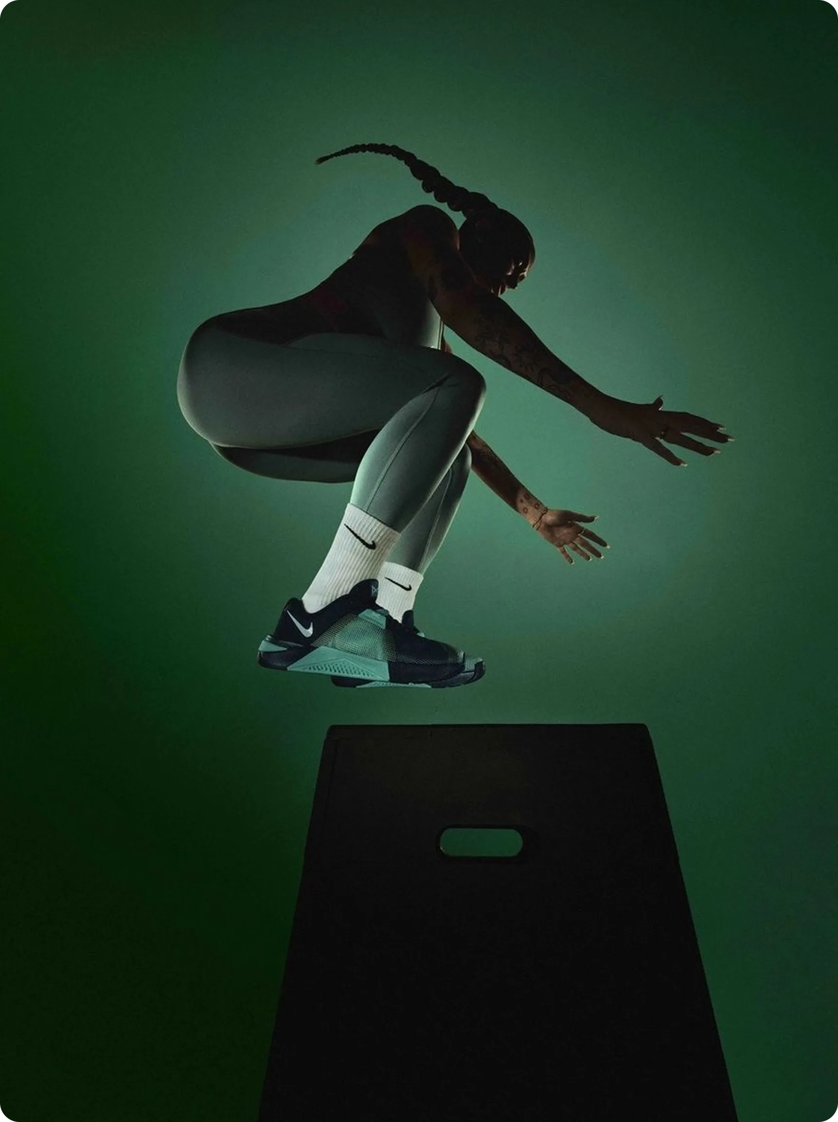 Power — athlete performing box jump, green lighting