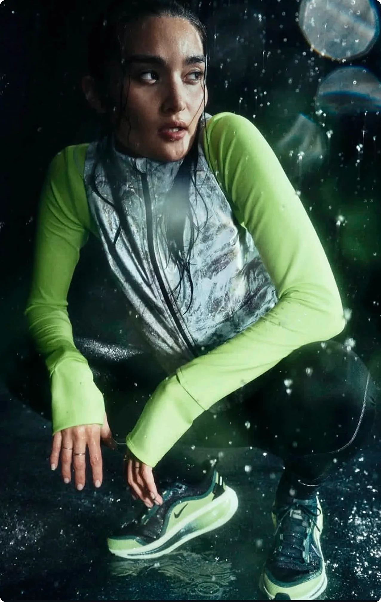 Nike Vomero — athlete in rain gear, neon yellow and reflective