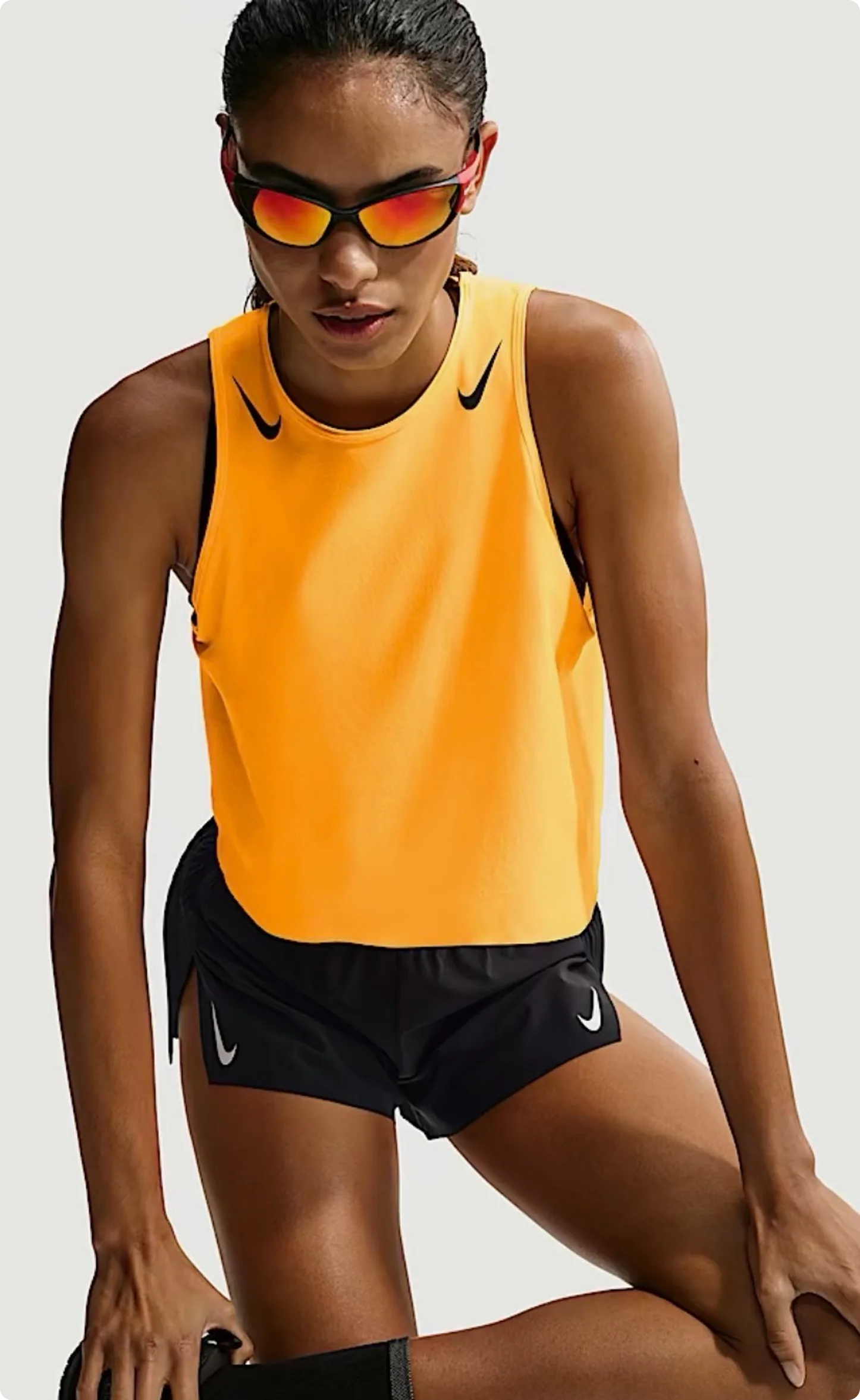 E-Commerce — athlete in orange Nike top with sunglasses